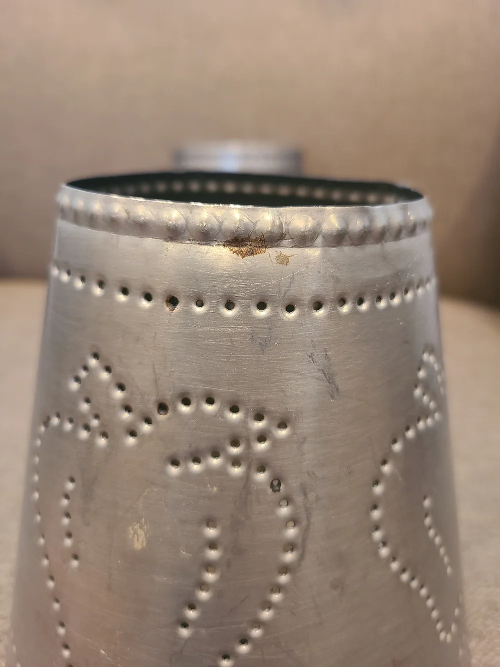 Primitive Irvin's Punched Tin Lamp featuring a distinct apple
